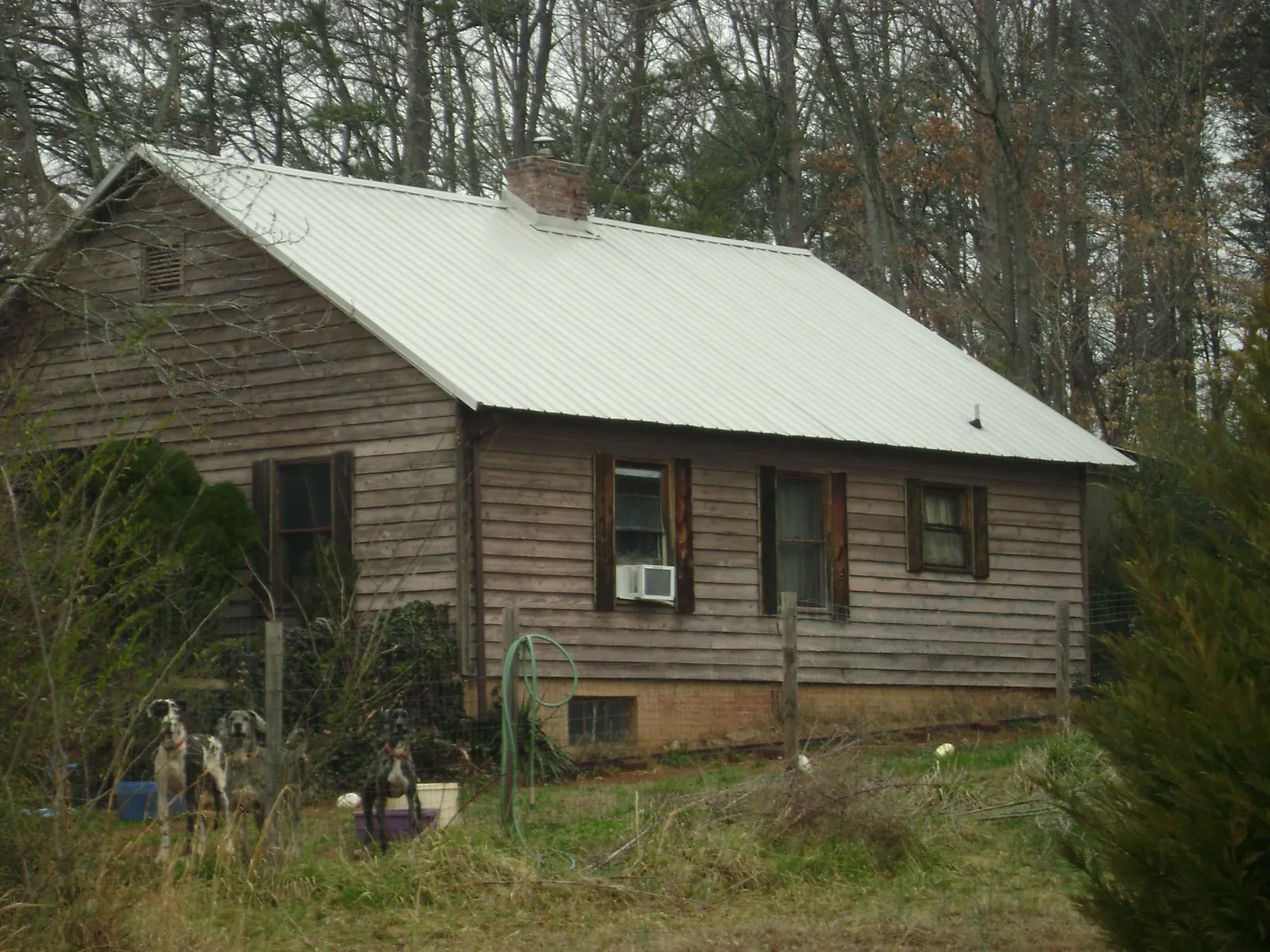 White metal roof on an old wood sided farmhouse, from a Metal Roof Installation job in Naval Anacost Annex